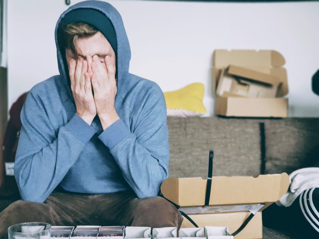Stressed man covering his face