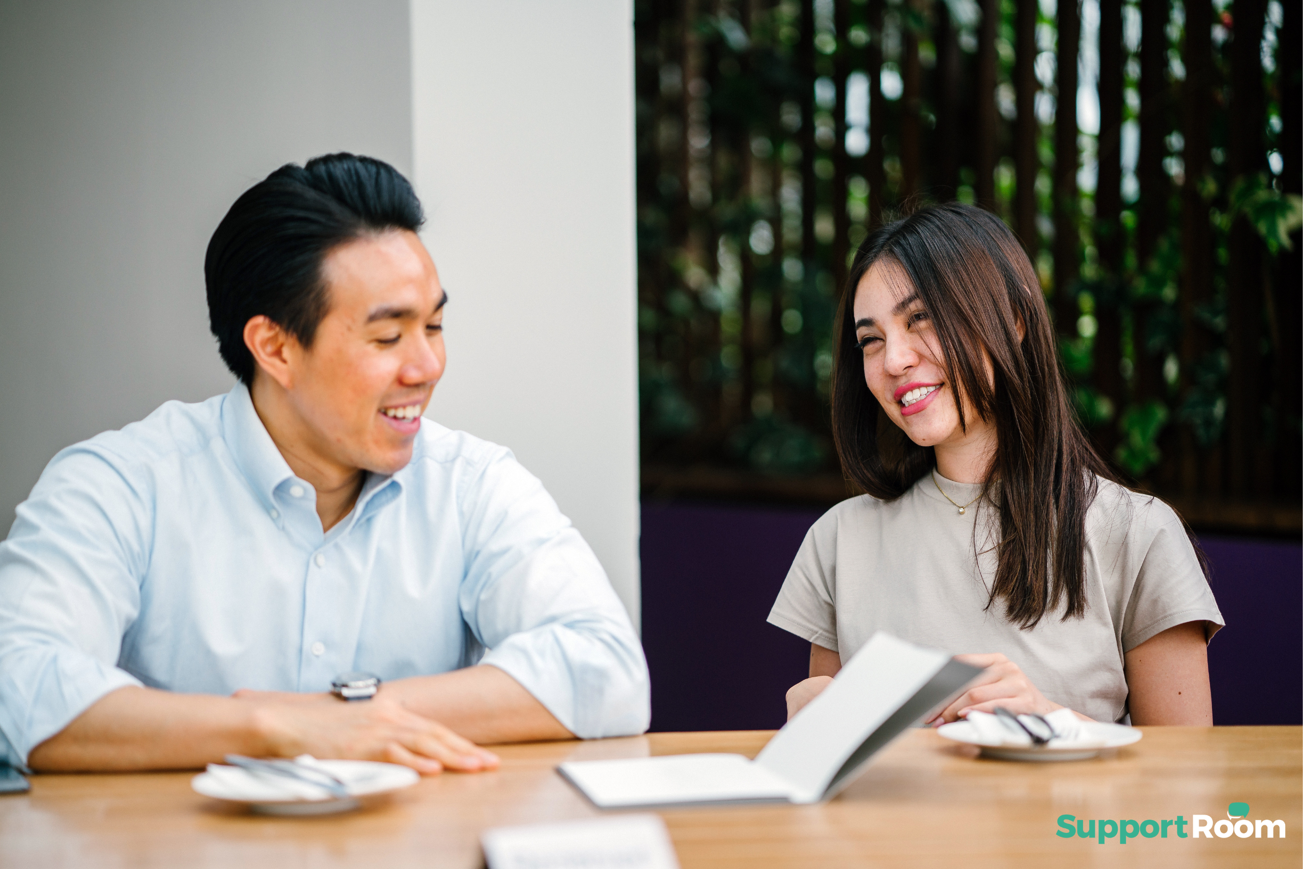 asian man and asian woman employee smiling at work